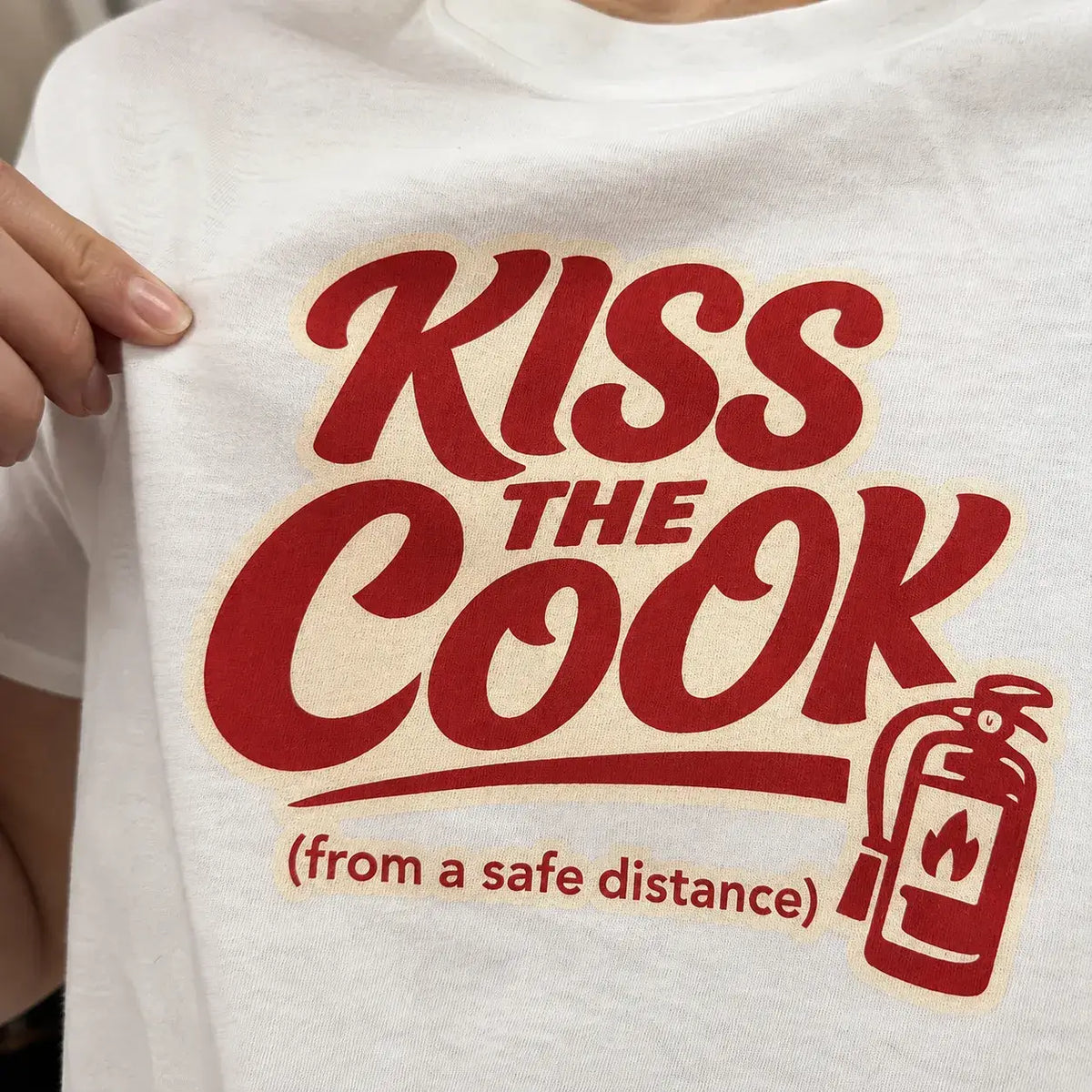 Kiss The Cook T-Shirt — Retro Red Graphic Tee ("Kiss The Cook from a safe distance")
