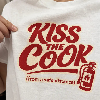 Kiss The Cook T-Shirt — Retro Red Graphic Tee ("Kiss The Cook from a safe distance")